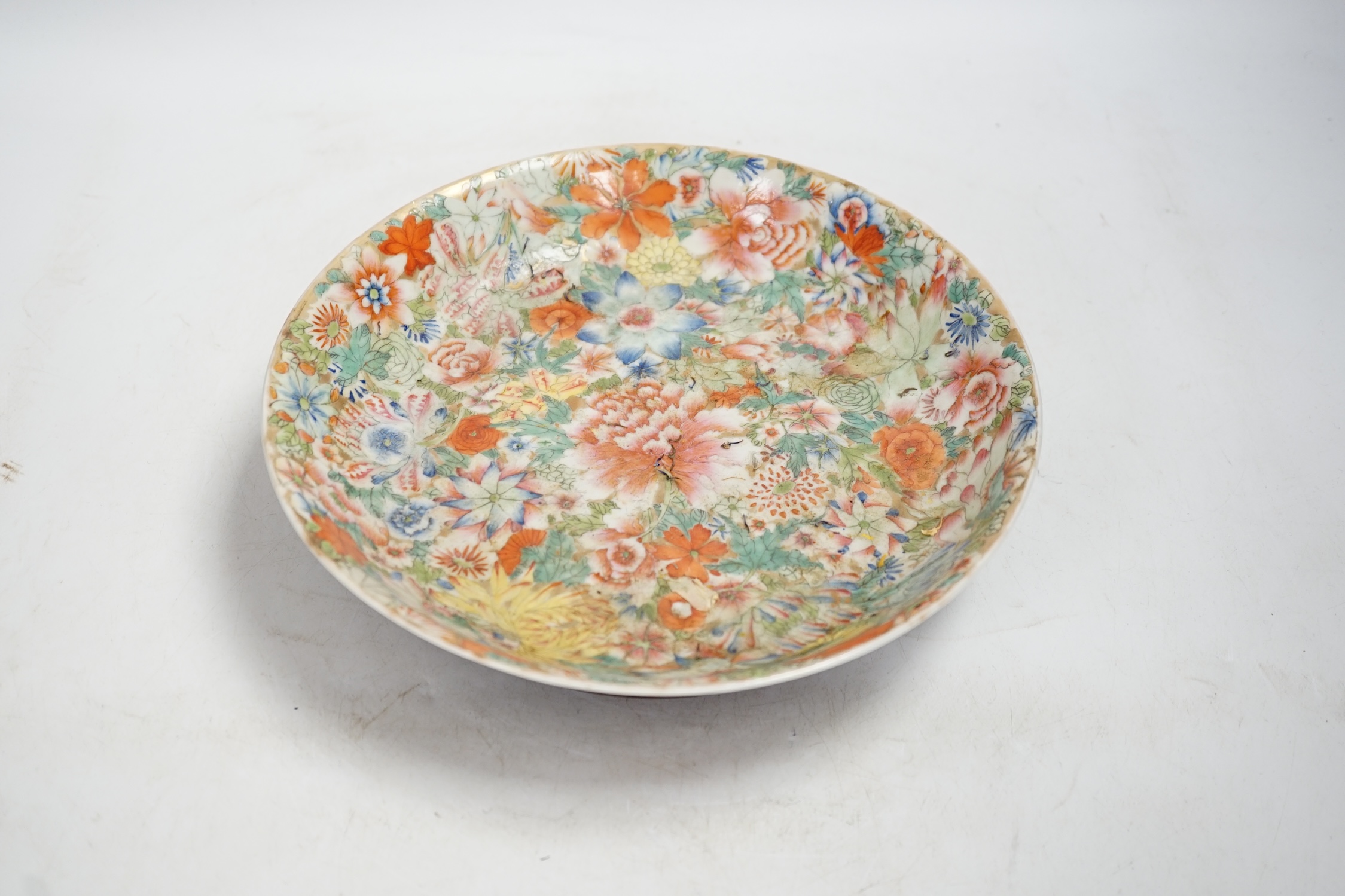 A Chinese enamelled porcelain millefleur dish, Qianlong mark, early 20th century, 24cm diameter. Condition - good